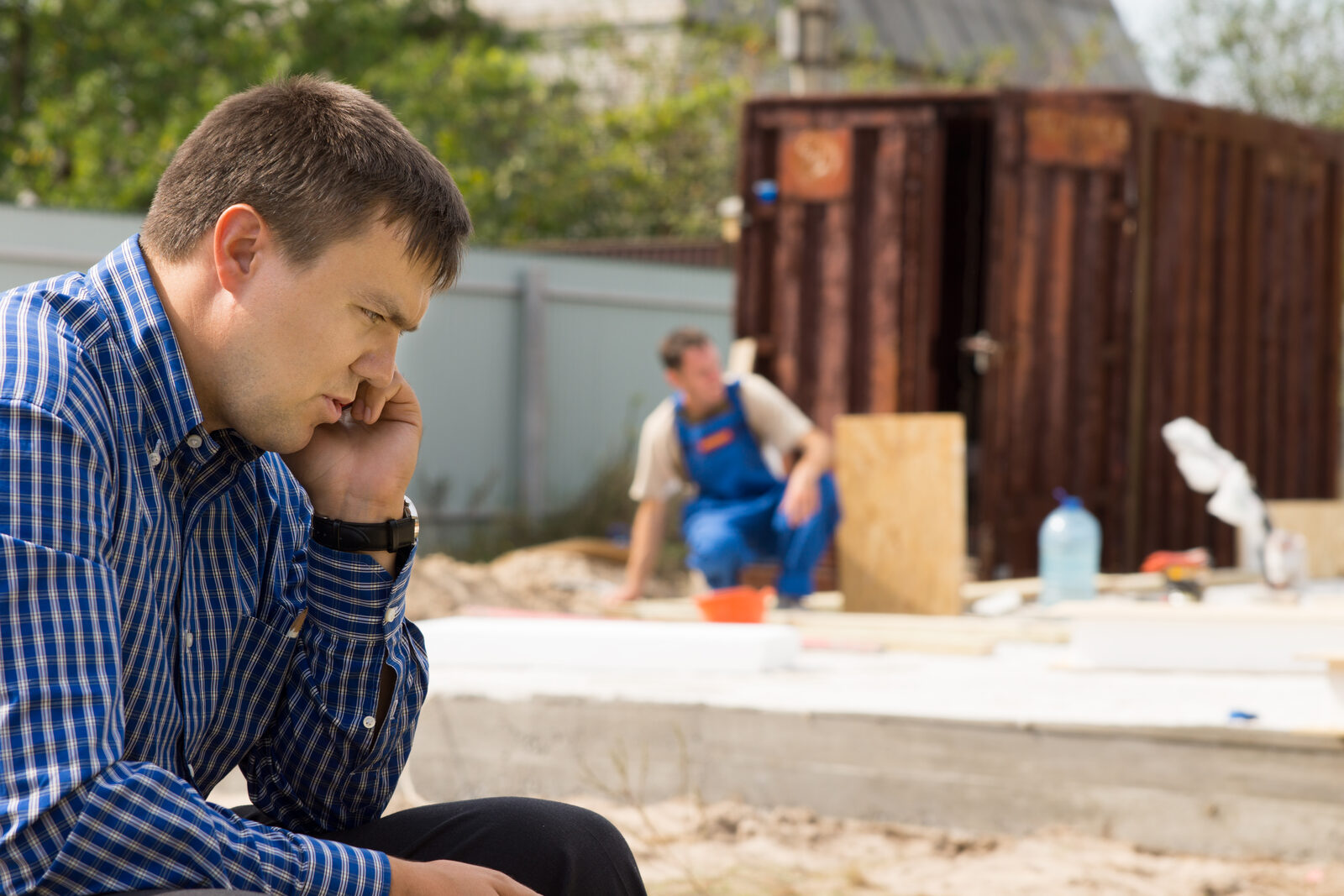 Contractor stressed on job site — without a scheduling system, workload becomes invisible